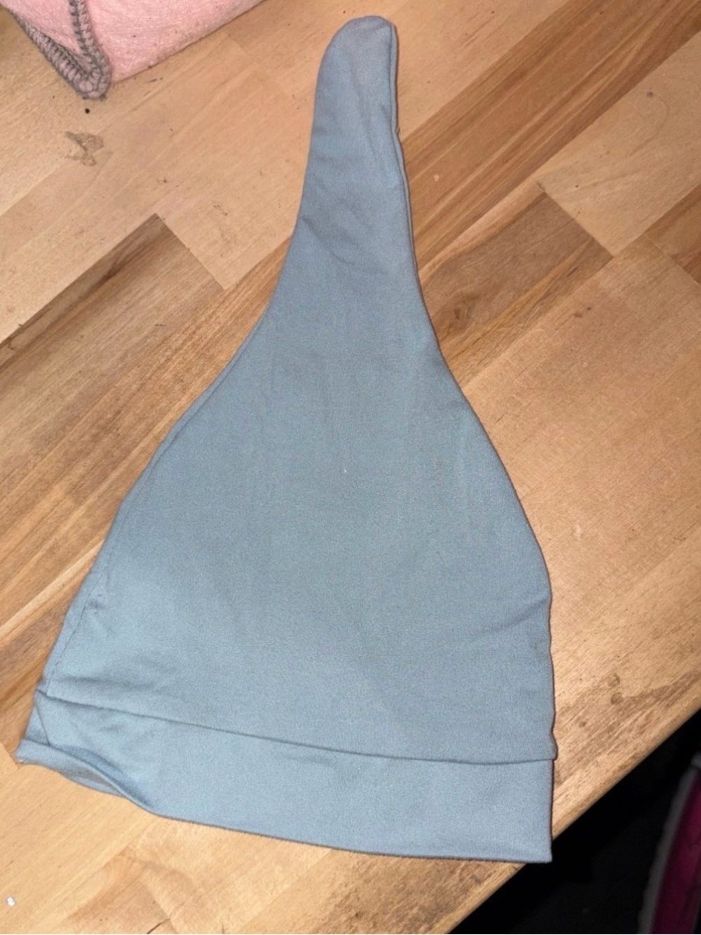 Blue baby beanie hat that can be tied at the top